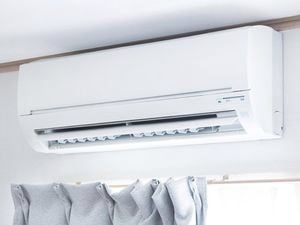 Split system air conditioner installed above the curtains.