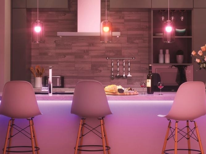 Smart colour changing light bulbs in lighting fixture over the kitchen counter top.