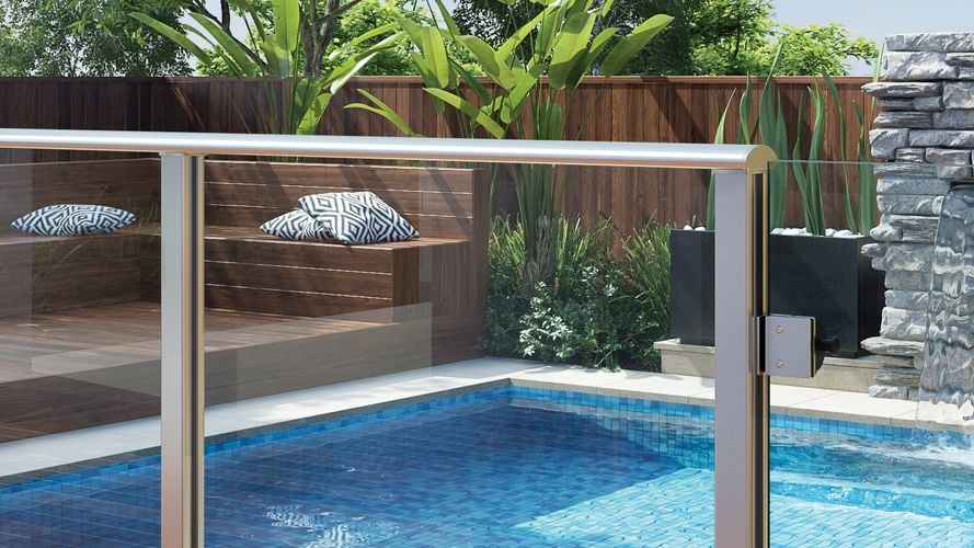 A clear pool fence overlooking a pool area