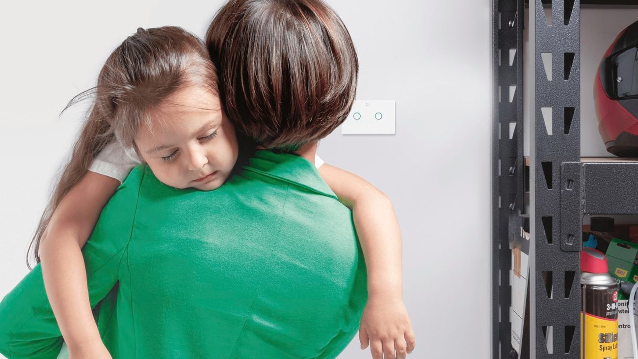 A woman in a green top carries a young girl