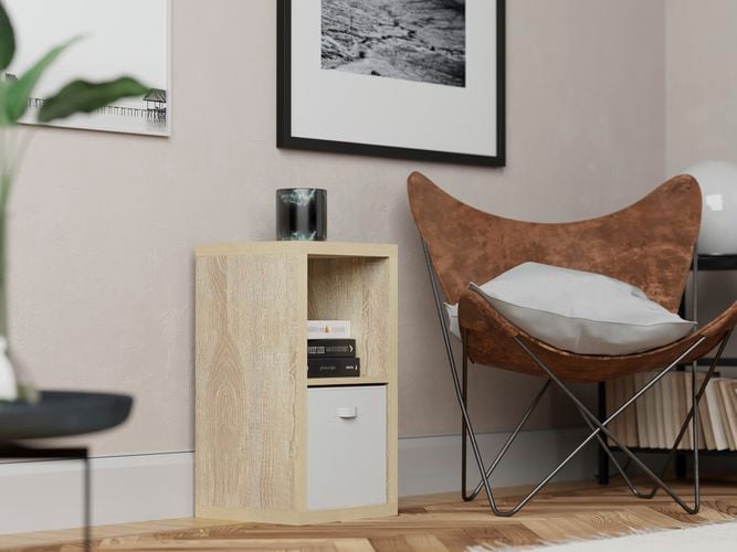 Lounge room with a chair and a shelving unit in it