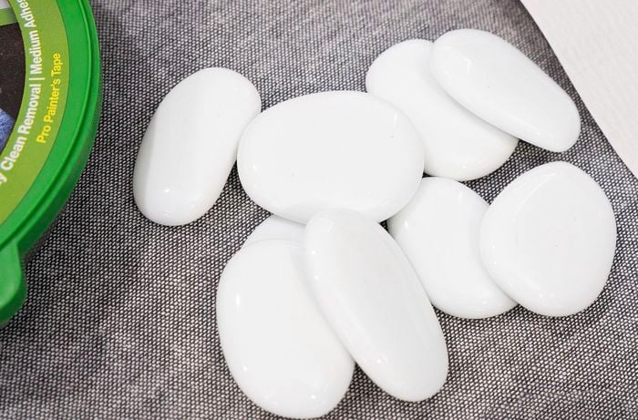 Nine flat white pebbles to use as playing pieces