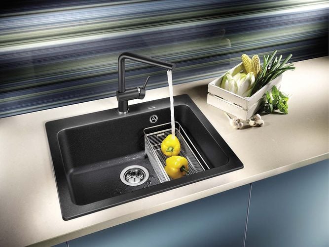 Person washing capsicums in a sink