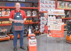 Rug Doctors carpet cleaner with a Bunnings team member standing beside the machine