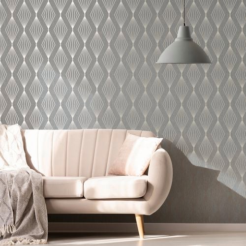 Sofa and a hanging lamp in front of a Boutique wallpaper wall.