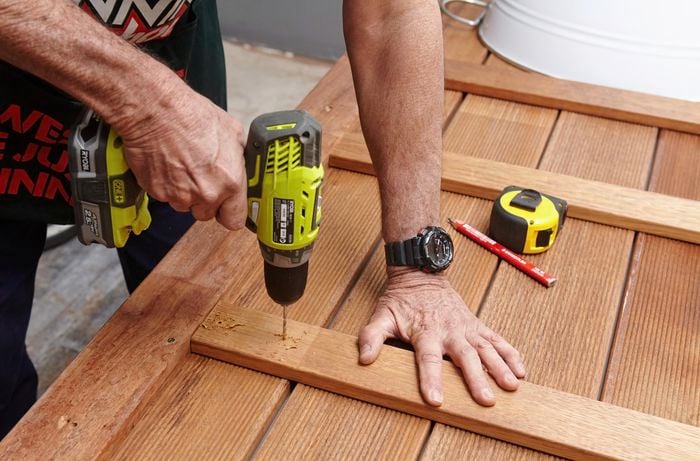 Person drilling bits of timber together.