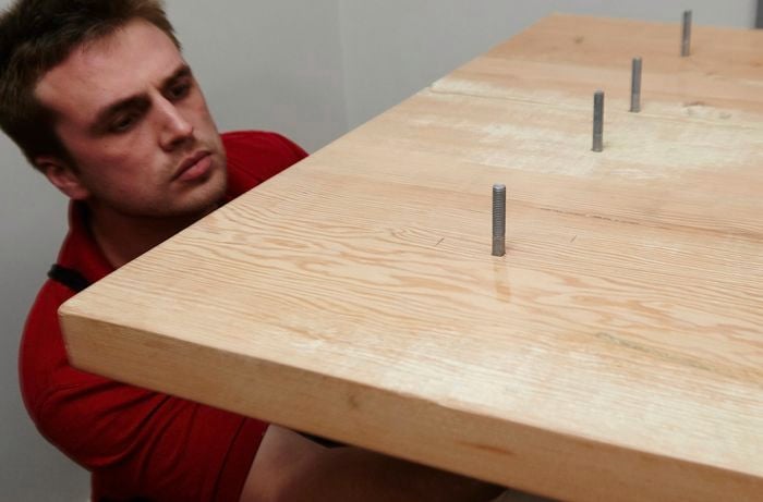 Bolts being positioned underneath an upturned tabletop for attaching legs