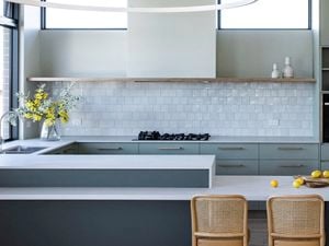 A kitchen showcasing assisted living design with comfortable seats for food prep and accessible oven and microwave