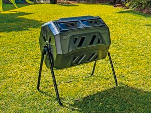 Composter and a raised garden bed in a backyard