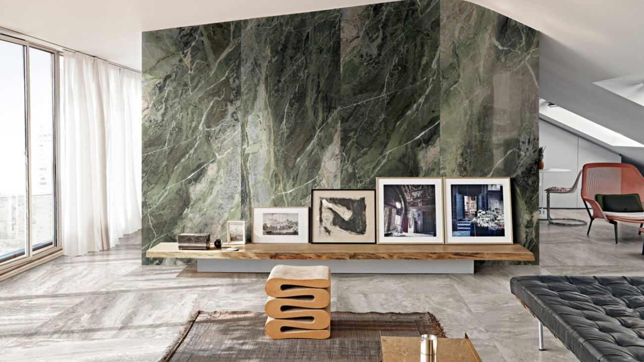Extra-large green-hued marble-like tiles adorn the feature wall of an upmarket living room