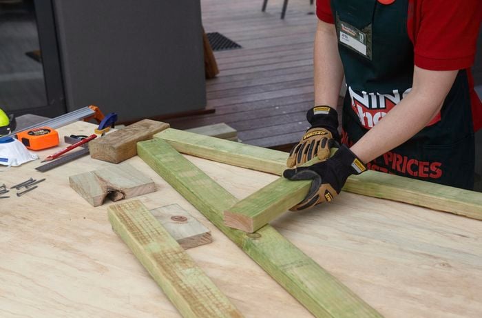 Bunnings team member Jess assembling a timber A frame