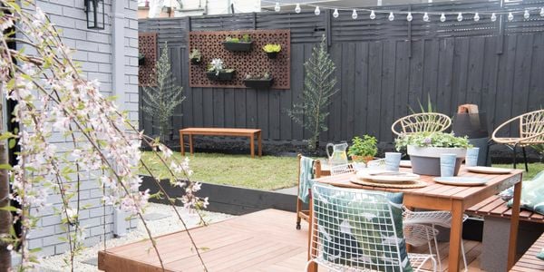 Backyard with modular decking, outdoor furniture and vertical garden.