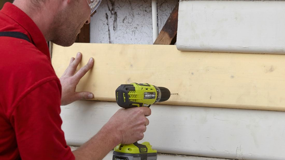 A replacement weatherboard being drilled into with a power tool