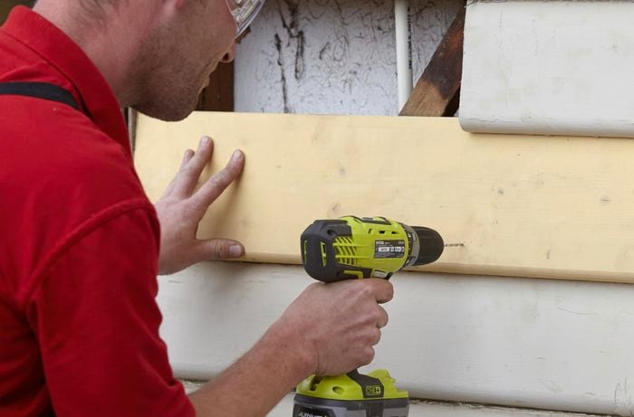 A replacement weatherboard being drilled into with a power tool