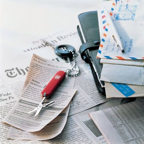 A swiss army knife on some newspaper cuttings.