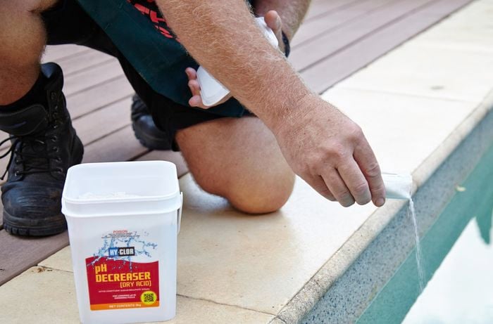 Dry acid being added to a pool