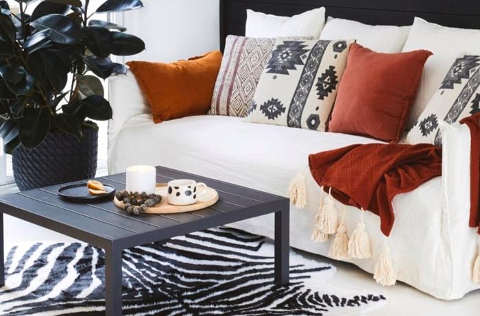White couch with assorted pillows