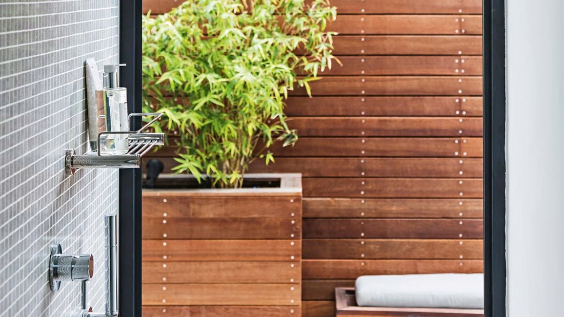 Shower with a large window looking outside.