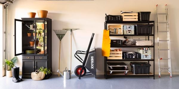Organised garage with shelving and cabinet.