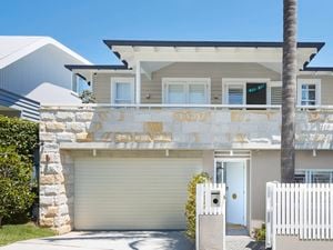 Crean sandstone brick house with cream garage door