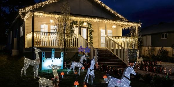 Christmas lights on and working at house 