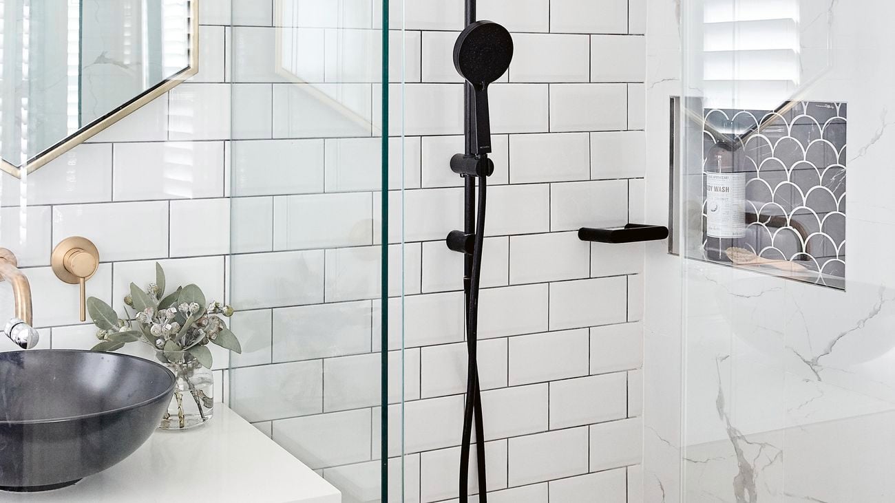 Modern bathroom with white tiles and black shower fixture
