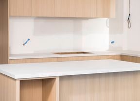 The image shows a freshly fitted kitchen with laminate benchtop.