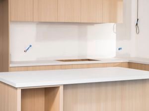 The image shows a freshly fitted kitchen with laminate benchtop.