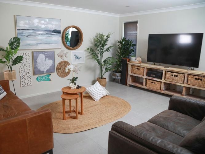 living room with floating shelves on wall