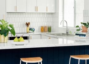 blue and white kitchen with tiled splashback and white benchtops