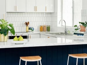 blue and white kitchen with tiled splashback and white benchtops
