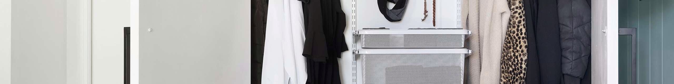 A neatly organised wardrobe with hanging rails, shelves, baskets and a pegboard    