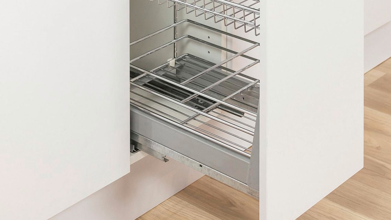 Kitchen cabinet drawer half pulled out, showing the slide out baskets inside.
