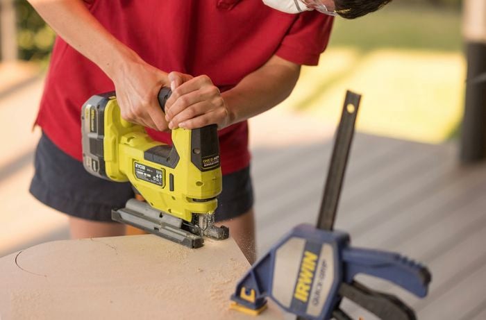 Using a brushless jigsaw to cut MDF board.