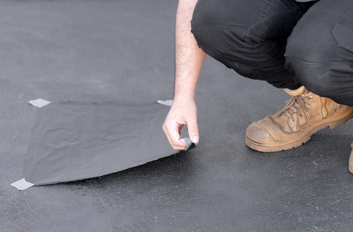 5. Doing  a moisture test on a concreted driveway