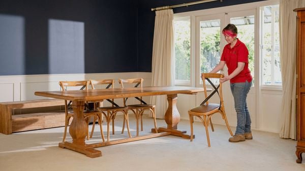 A Bunnings Team Member is preparing the area by clearing away any furniture from the floor to ensure you have full access to the carpet.