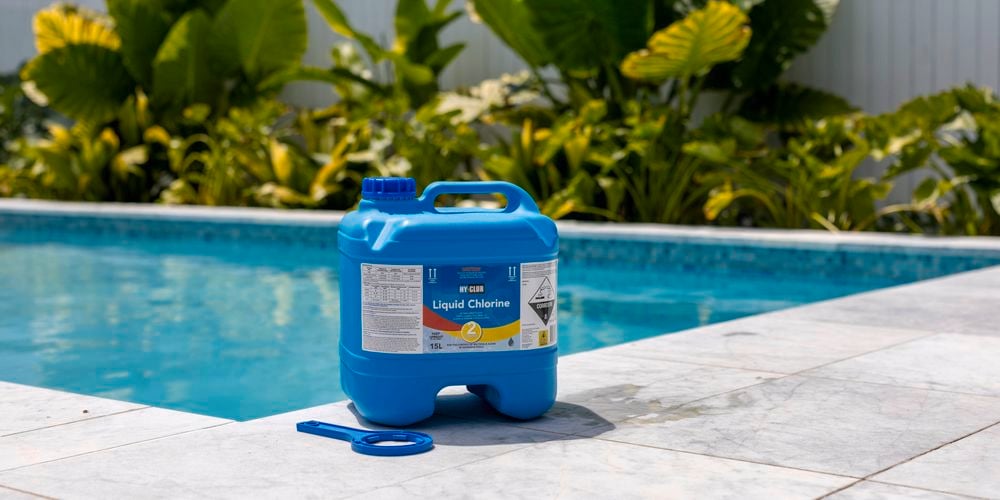 Image of Clorine bottle in shot next to a pool 