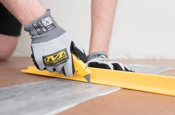  Cutting vinyl plank using a knife and safety ruler