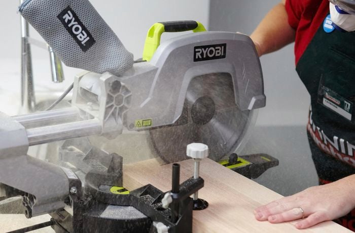 Person using circular saw to cut piece of timber to size.