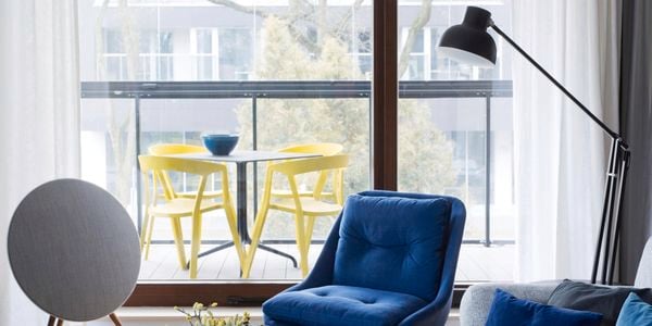 White coffee table with blue chair