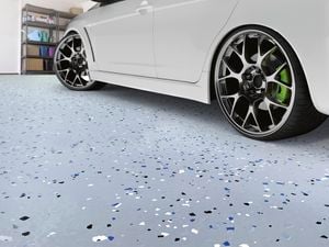 Close up of a car on a finished epoxy garage floor.