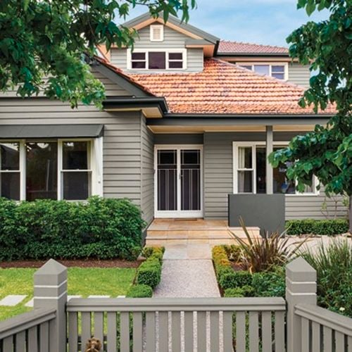Front facade of a two storey weatherboard house painted in timbercolour