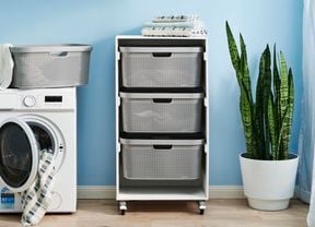 laundry cart in a laundry room with washing machine on the left