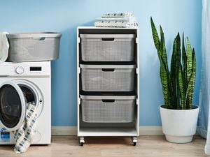 laundry cart in a laundry room with washing machine on the left