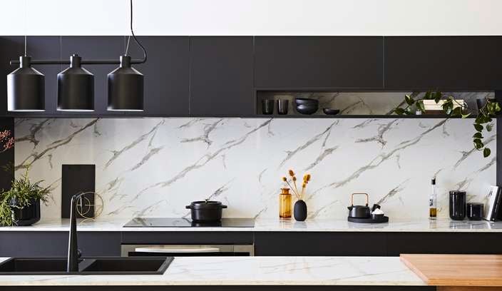 Modern monochrome kitchen with a marble splashback
