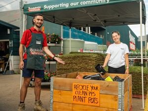 Recycle your plastic plant pots with us team with sign 