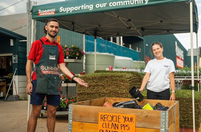 Recycle your plastic plant pots with us team with sign 