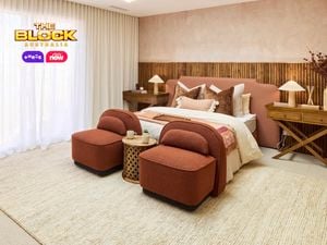  Bedroom with peach tones, wooden accents, and two upholstered chairs.