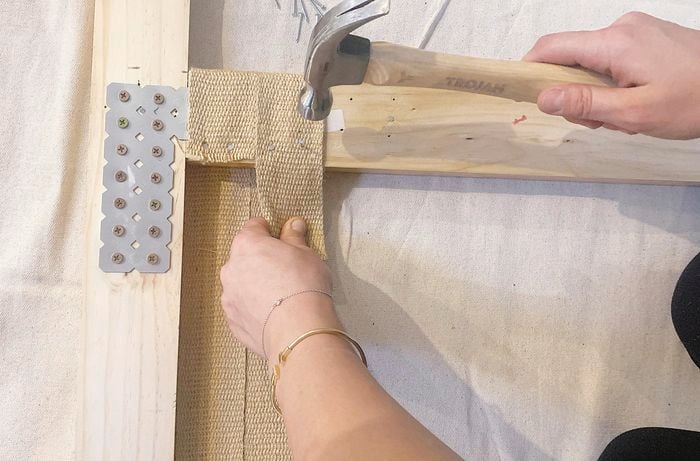 hammering jute strips to timber