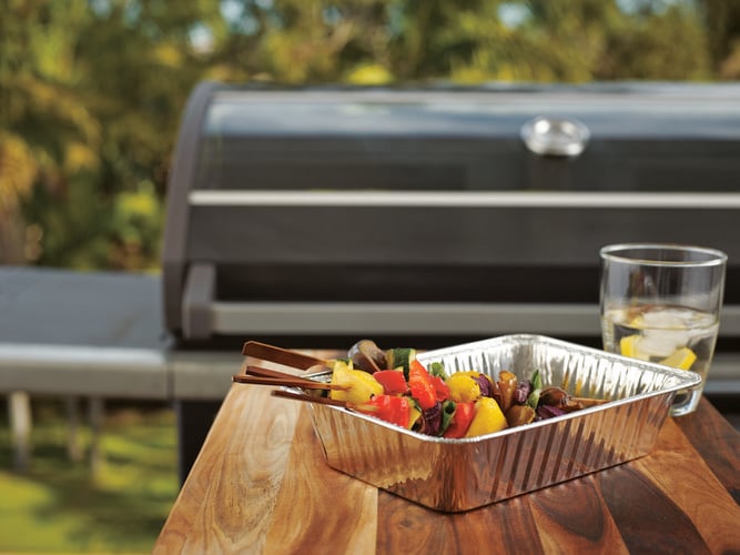 Skewered meats and vegetables in a tray